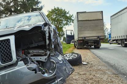 A truck and car collision results in severe damage. 